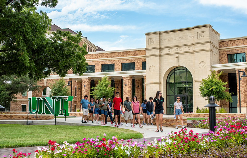 A group begins a tour from the UNT Welcome Center.